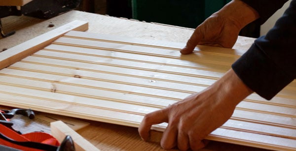 Measure then cut the wood board you'll use for your backdrop