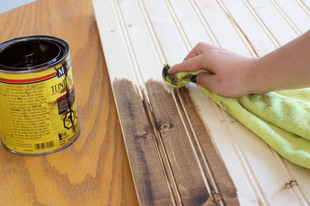 Use an old cloth to apply the wood stain to your wood photography background