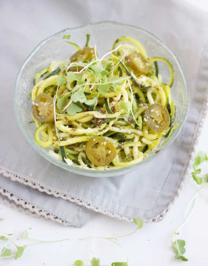 Homemade zucchini noodles topped with a spicy jalapeno pesto sauce