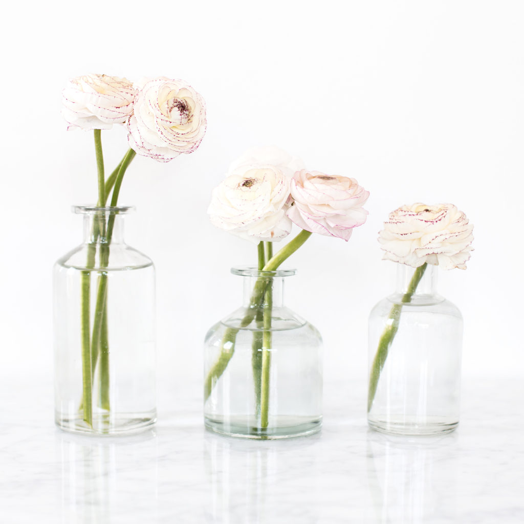 Here are some simple ways to bring more positivity into your life! (image: White roses in three clear vases with water)