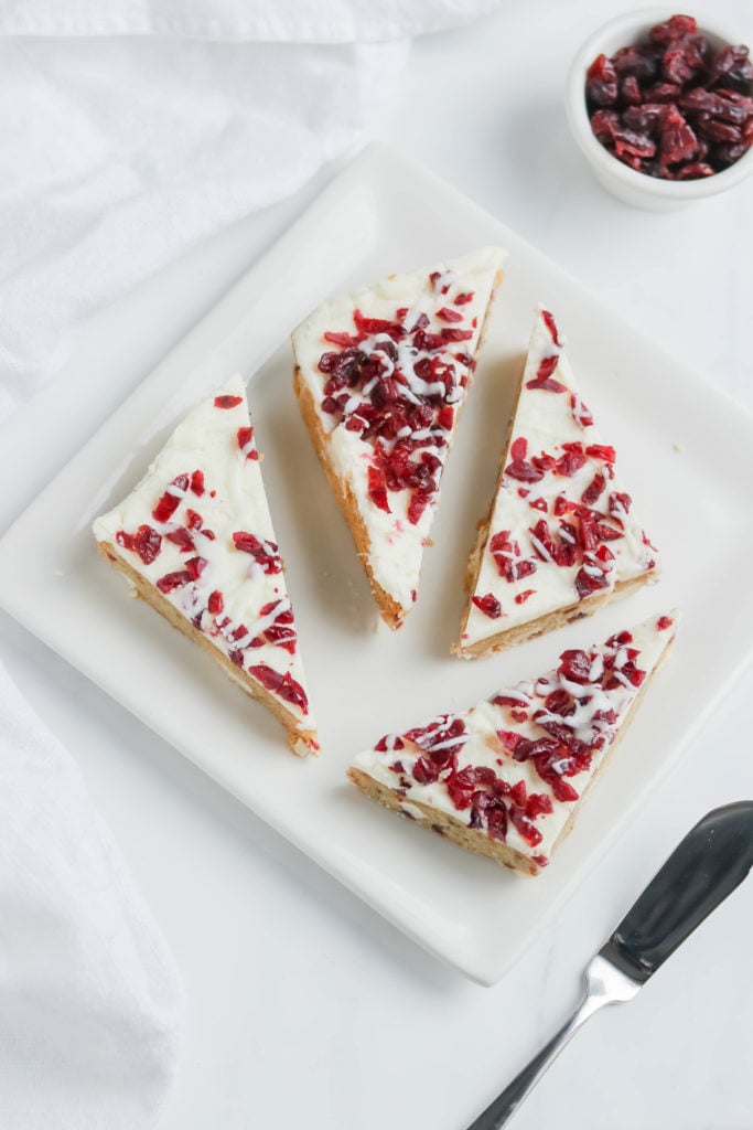 These vegan cranberry bliss bars are a holiday favorite dessert, packed with sweet cranberries and topped with vanilla icing.