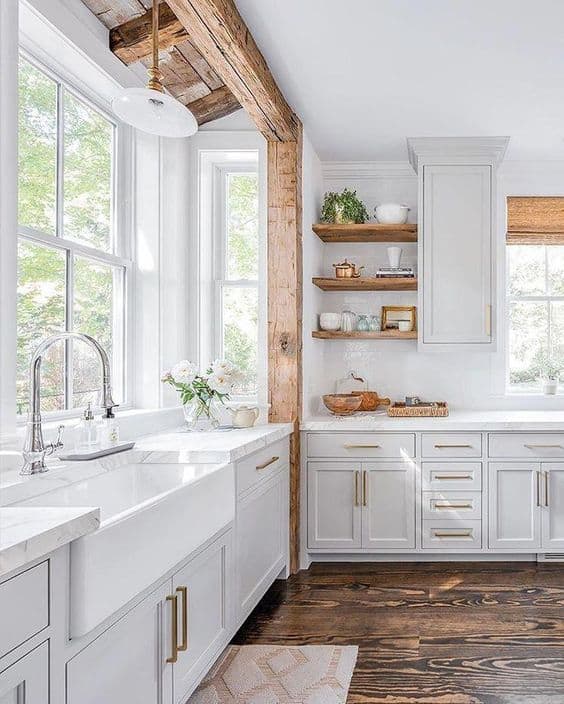 Tips for styling a farmhouse kitchen; white kitchen with wood beam. white farmhouse sink, open shelving in kitchen