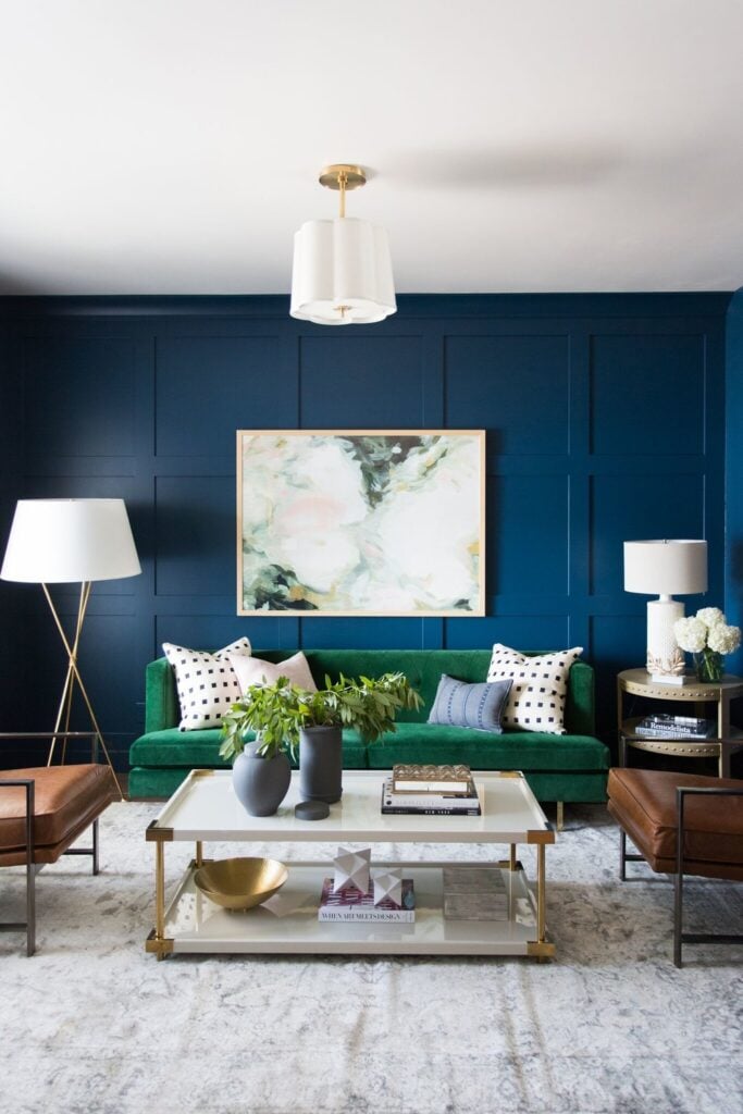 Studio Mcgee living room, Dark blue walls, Navy living room, green couch 