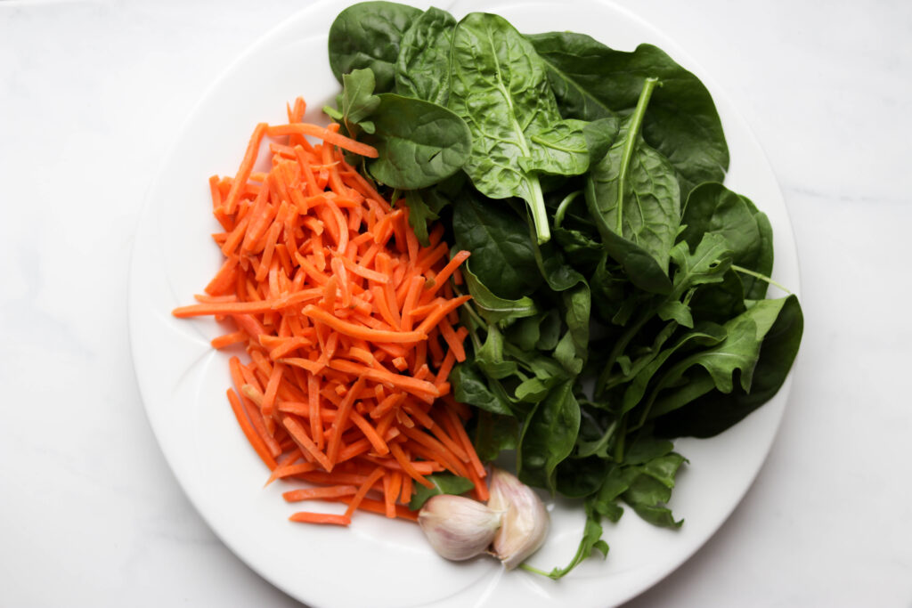plate of carrot, spinach and garlic