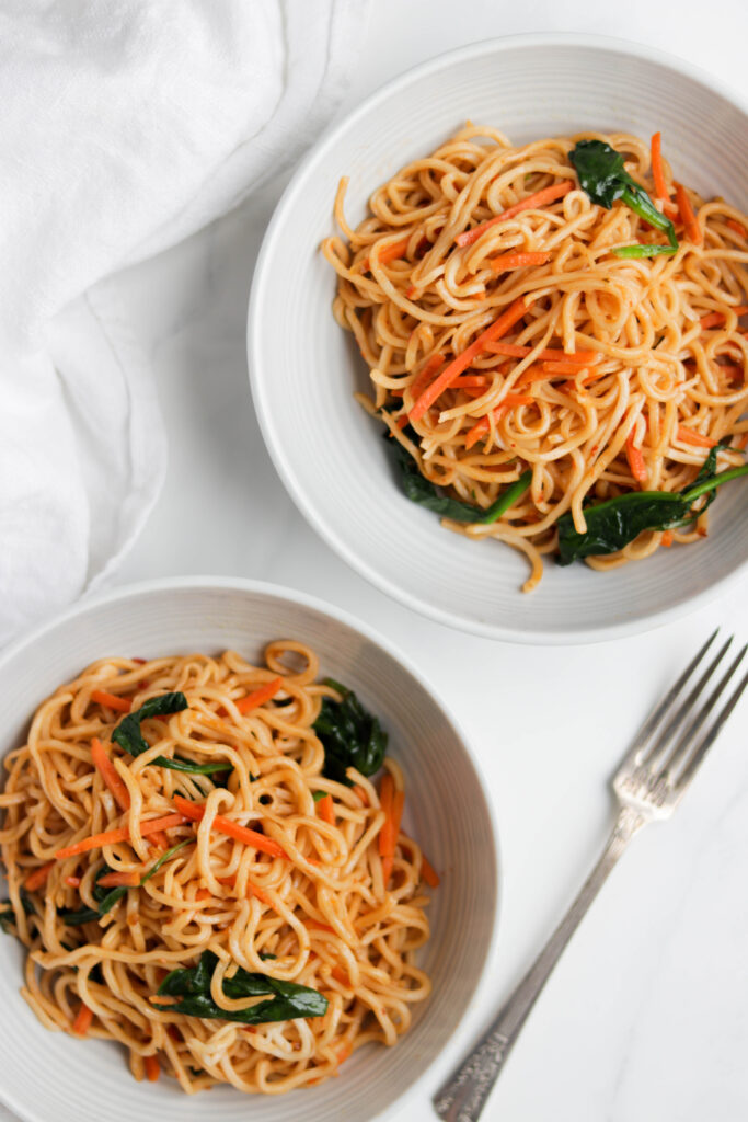 This Easy Vegan Noodle Stir Fry is made with fresh vegetables, Tamari sauce, garlic, and spiced up with optional Sriracha sauce. This healthy dish can be made in less then 30 minutes! #veganstirfry