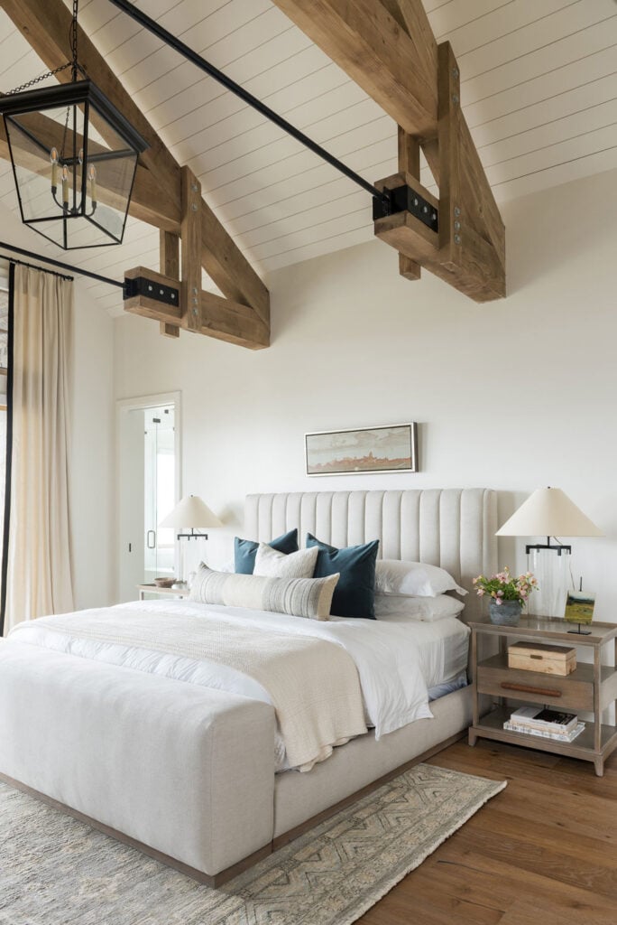 Studio McGee by Bedrooms: SM Ranch House; rustic beams white walls, natural bedding