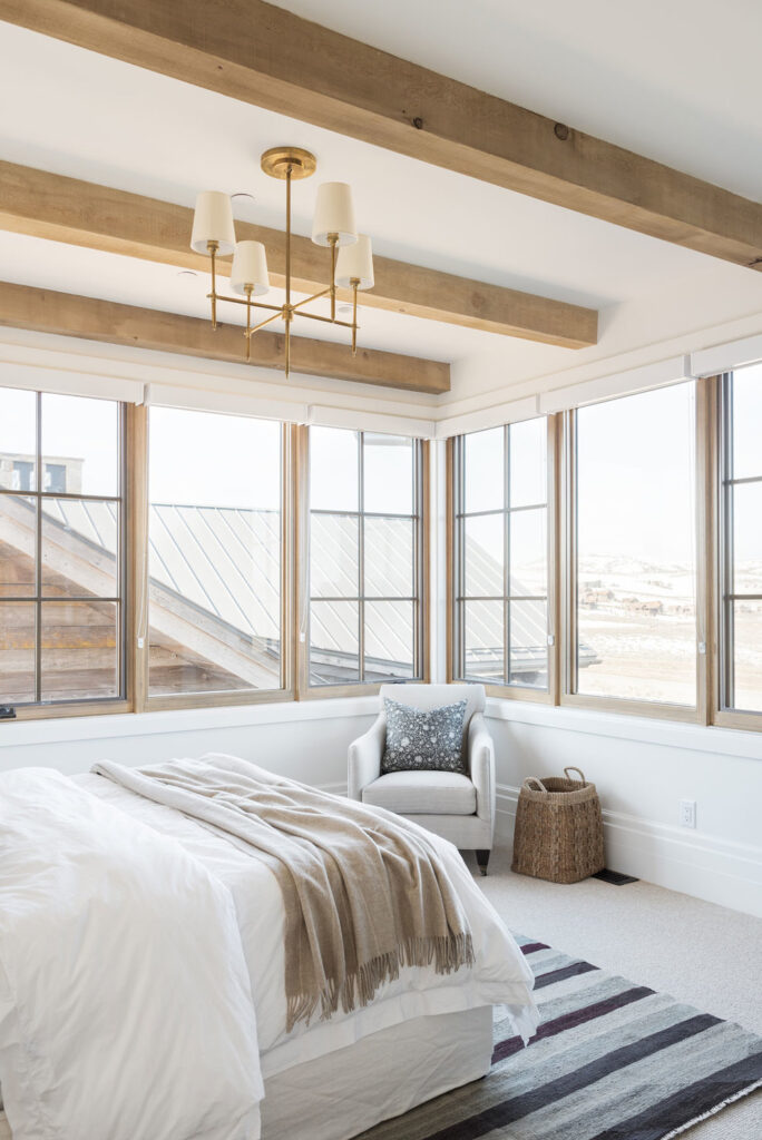 Studio McGee by Bedrooms: SM Ranch House; rustic beams white walls, natural bedding