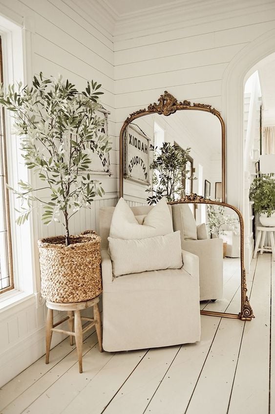 Antique mirror against wall, gold frame; Farmhouse Wall Decor Ideas