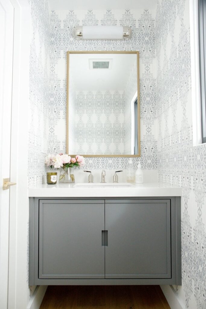 Bathrooms by Studio McGee; grey vanity, white counter top, wallpaper, small bathroom, gold mirror