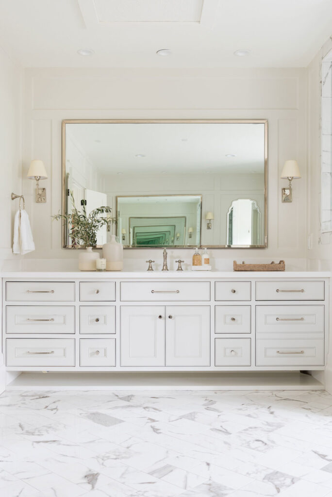 Bathrooms by Studio McGee; white vanity, large mirror, white bathroom
