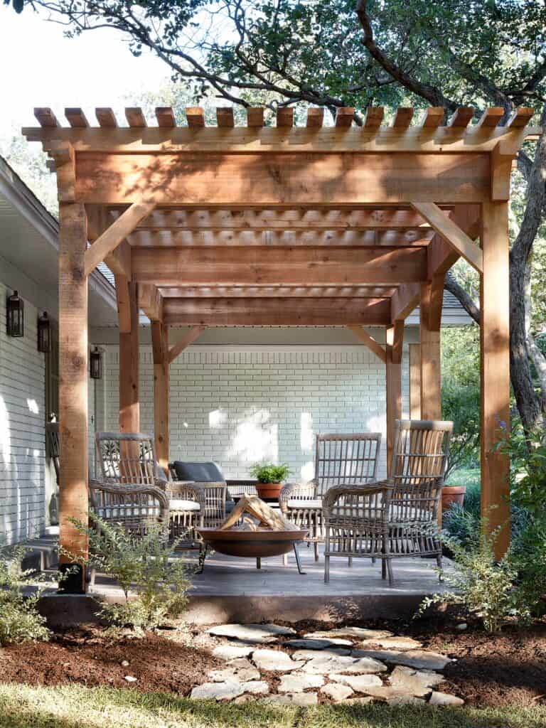 wood Pergola, wicker outdoor furniture - Top Outdoor Spaces by Joanna Gaines; best backyard, garden and patio areas redone by Joanna Gaines from Fixer Upper