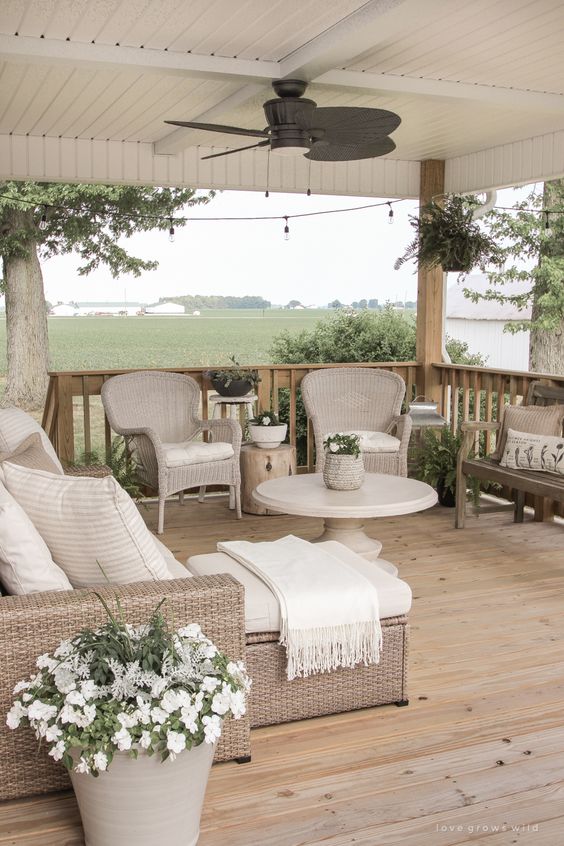 Tips for Styling your Deck this Summer; deck greenery, plants on deck, beige deck, beige outdoor furniture