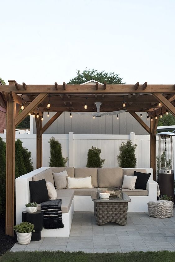 Tips for Styling your Deck this Summer; gazebo with string lights, white fence, outdoor sectional