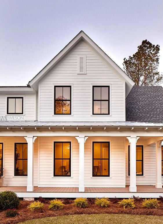 Modern Farmhouse Design Must haves: front porch, sitting area, open porch, white siding, black windows