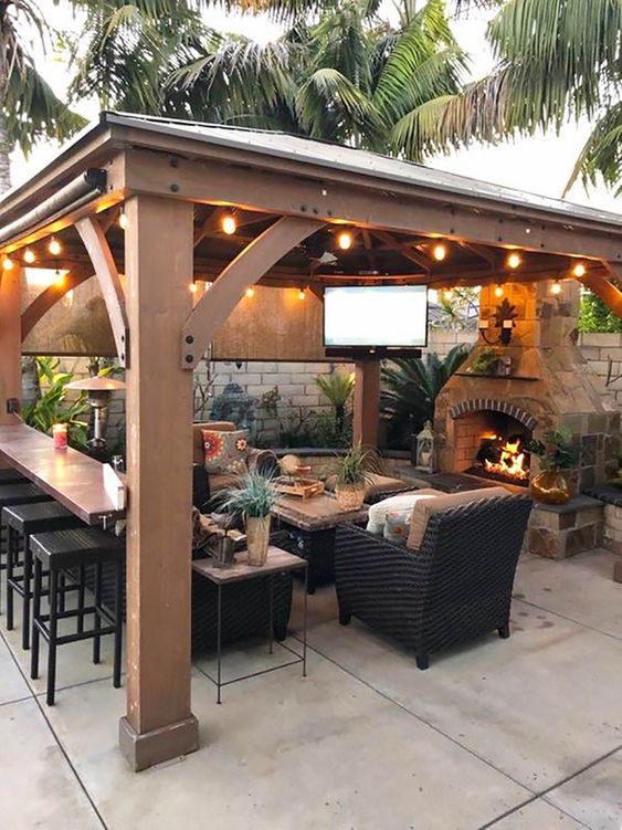 Tips for Styling your Deck this Summer; backyard gazebo idea, string lights, outdoor tv, outdoor fireplace.