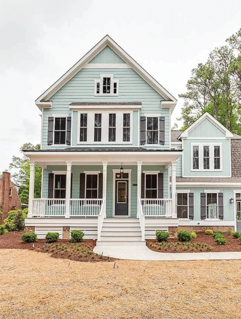 mint green exterior on a modern farmhouse, bush landscape, porch - 11 Beautiful Modern Farmhouse Exteriors; here are several country farmhouses that are sleek with character and rustic charm.