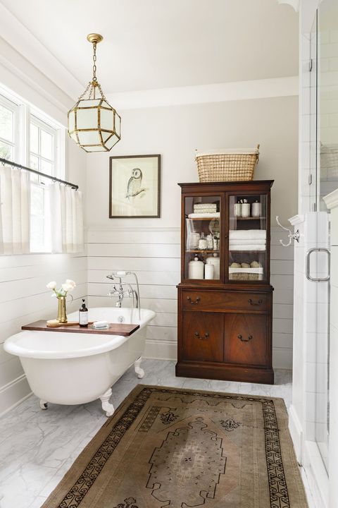 Modern Farmhouse Design Must haves: farmhouse bathroom, claw foot tub, white, wood linen cabinet, shiplap in bathrooms