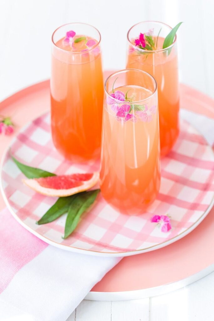 Delicious Summer Cocktail: Citrus Champagne Punch - made with orange and grapefruit juices, simple syrup, and grenadine. 