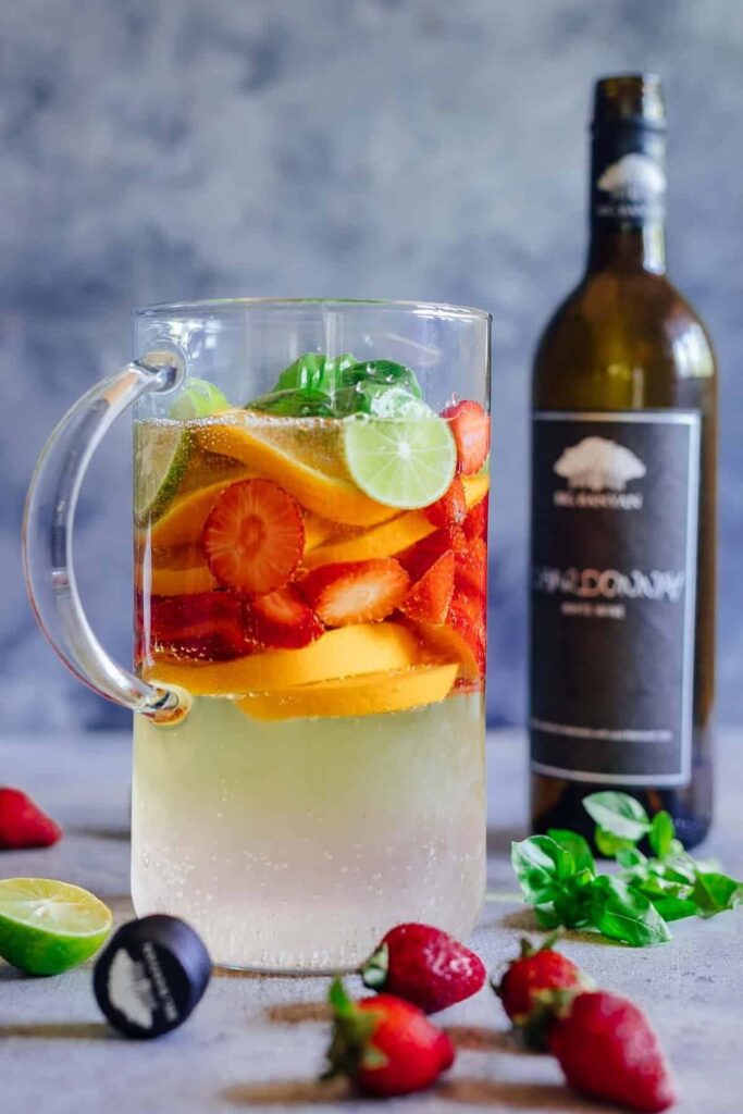 Delicious Summer Cocktails: Strawberry Orange White Wine Sangria - strawberries, oranges, lime and basil with white wine