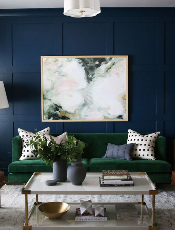 Behind Couch Decor Ideas for Your Living Room; dark accent wall, wood trim accent wall, green couch, abstract art above couch