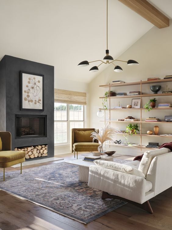 Best NEW Living Rooms by Joanna Gaines from Fixer Upper; dark grey fireplace, shiplap, white couch, shelves