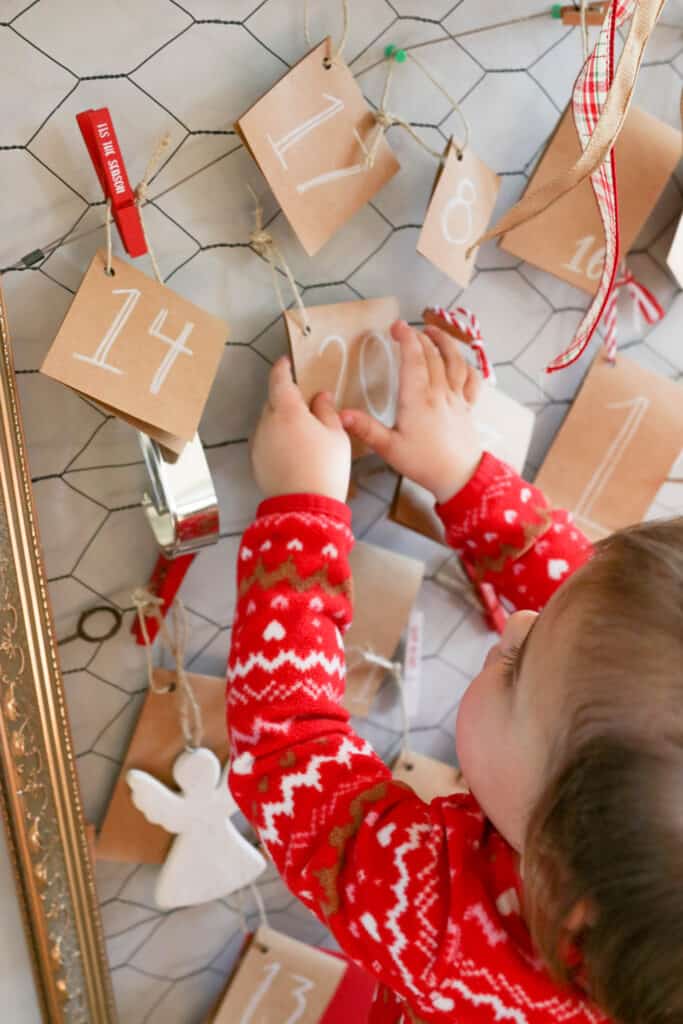 Our Christmas Activity Advent Calendar; everyday until Christmas, our toddler will open a hanging card to see what fun Christmas activity or adventure we will be doing that day! Chocolate free advent calendar idea!