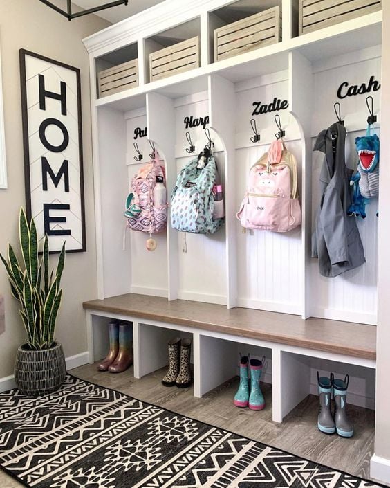 39 Tips to Decorate a Mudroom on a Budget; names above hooks