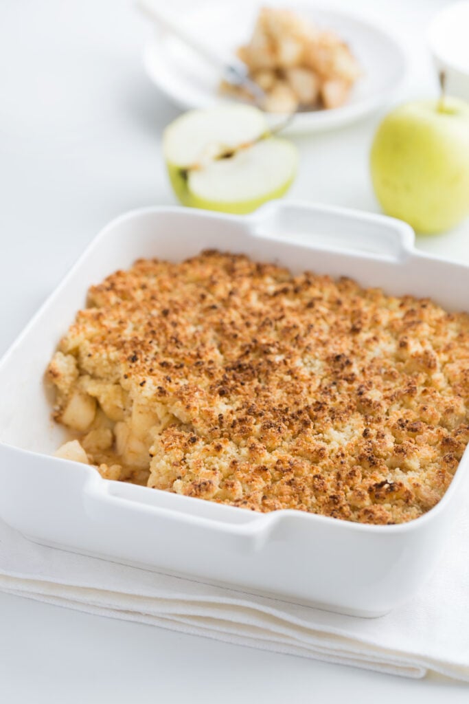 Cinnamon Apple Crumble Recipe; this apple dessert is made with apples, sugar, flour, butter and cinnamon! The ingredients are combined in a baking dish, covered with crumble topping and baked until golden brown.