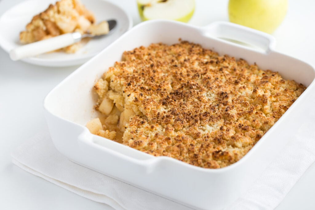 Cinnamon Apple Crumble Recipe; this apple dessert is made with apples, sugar, flour, butter and cinnamon! The ingredients are combined in a baking dish, covered with crumble topping and baked until golden brown.