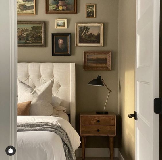 wall gallery above bed in bedroom as an accent wall