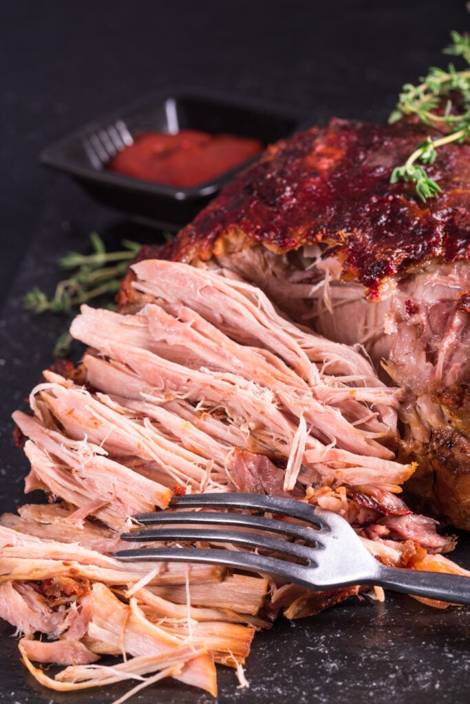 Pulling pork with fork - Spicy Pulled Pork Sandwiches Recipe; Homemade BBQ sauce with this pork shoulder for fall off the bone perfection! Great for lunch or dinner.