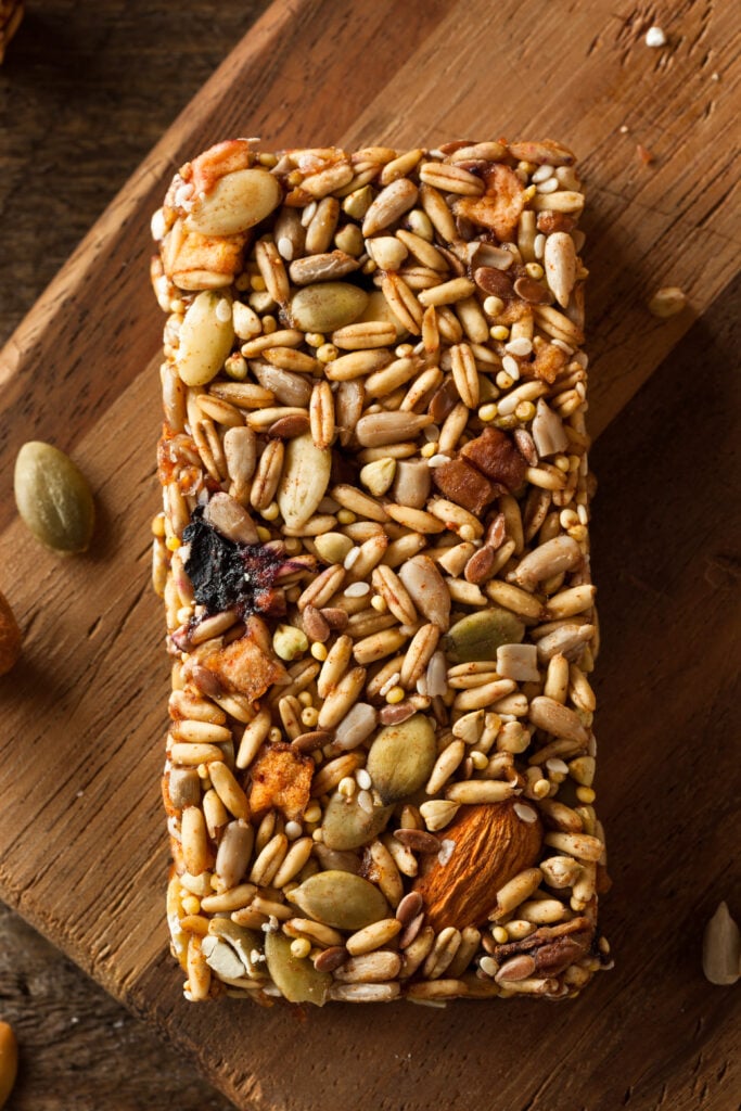 Homemade Granola Bar Recipe with Pumpkin Seeds; This easy raw granola bar recipe is backed with pumpkin seeds, sunflower seeds, rice puffs, and almonds.