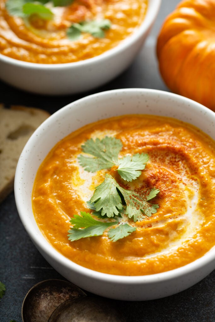 Thai Pumpkin and Carrot Soup Recipe; delicious 4 ingredient homemade soup recipe with thai curry, pumpkin, carrots and coconut milk! Vegan, dairy free, gluten free! Perfect Fall Recipe.