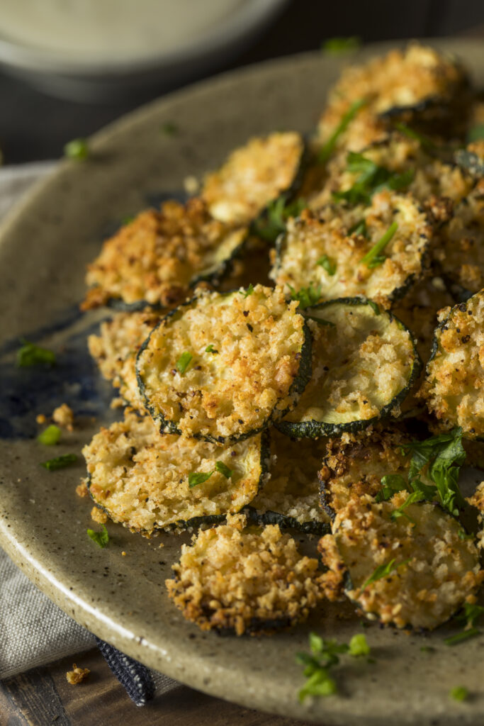 The Best Air Fryer Parmesan Zucchini Chips Recipe; quick 10 minute breaded zucchini chips that are crispy yet healthy! A delicious low/carb and keto-friendly snack or appetizer!