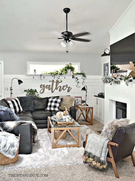 20 Beautiful Black Couch Living Room Ideas; black sofa, rustic living room with black couch, gather sign, white shiplap on wall