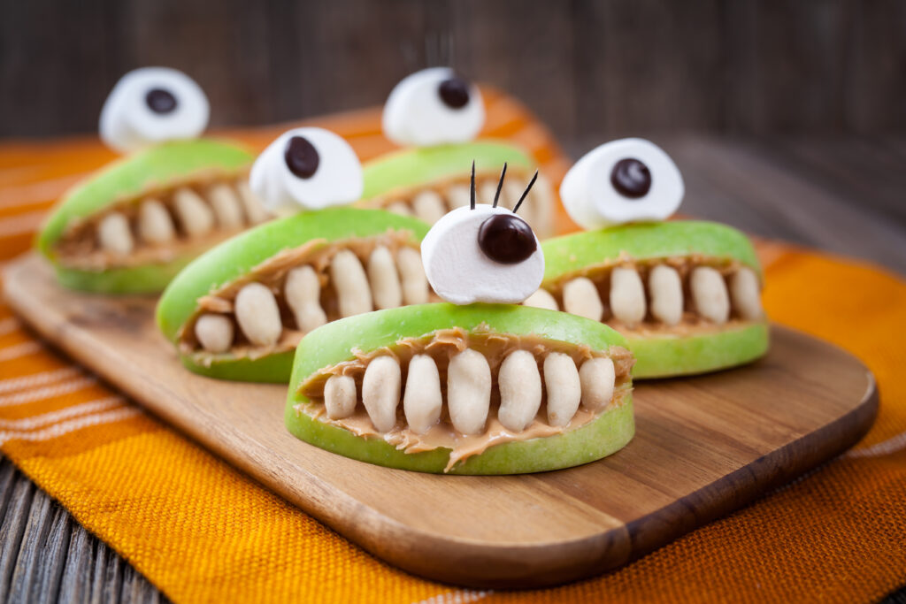 Halloween Apple and Peanut Butter Monster Mouths Recipe; simple healthy Halloween snack for kids using apples, peanut butter, peanuts, marshmallows and chocolate chips.