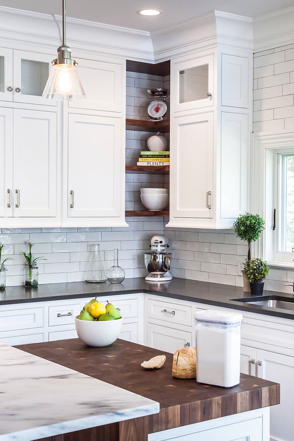 Black Quartz Countertops in white kitchen, butcher block counter, open corner shelving