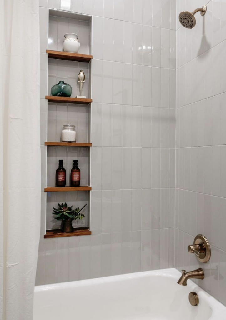 Vertically Stacked Tile with Teak Wood Shelves shower niche
