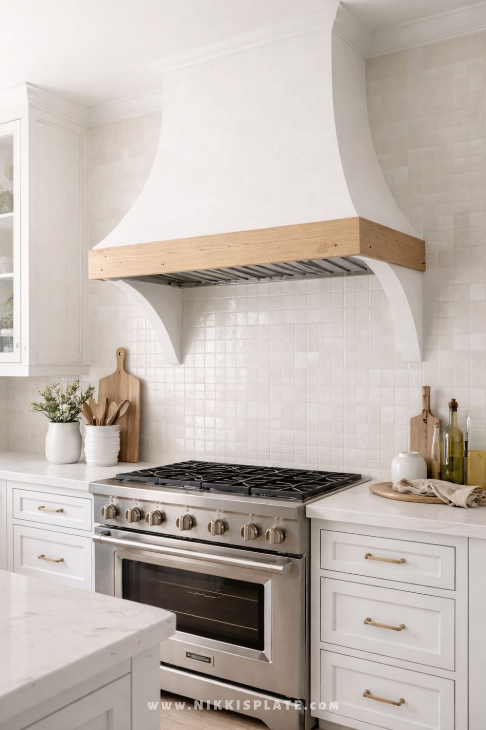 white plaster farmhouse range hood with wood trim in bright neutral kitchen
