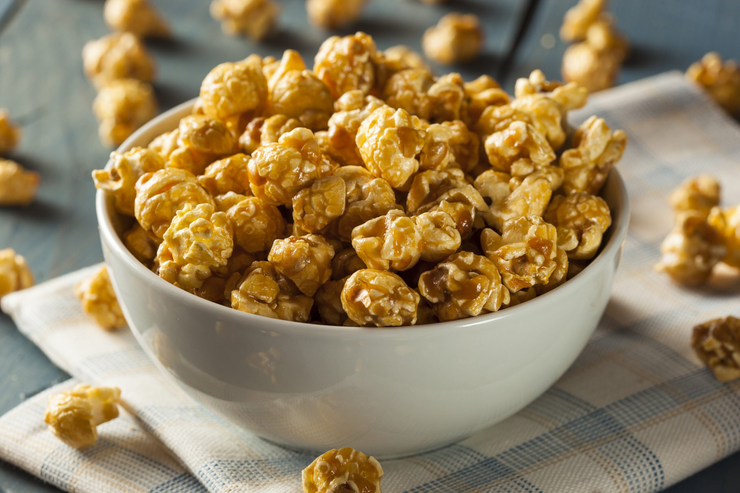 Homemade Golden Caramel Popcorn in a Bowl - Chewy Caramel Coated Popcorn Recipe; a chewy gooey version of caramel popcorn! Packed into pretty decorative bags, makes a great gift for family and coworkers!