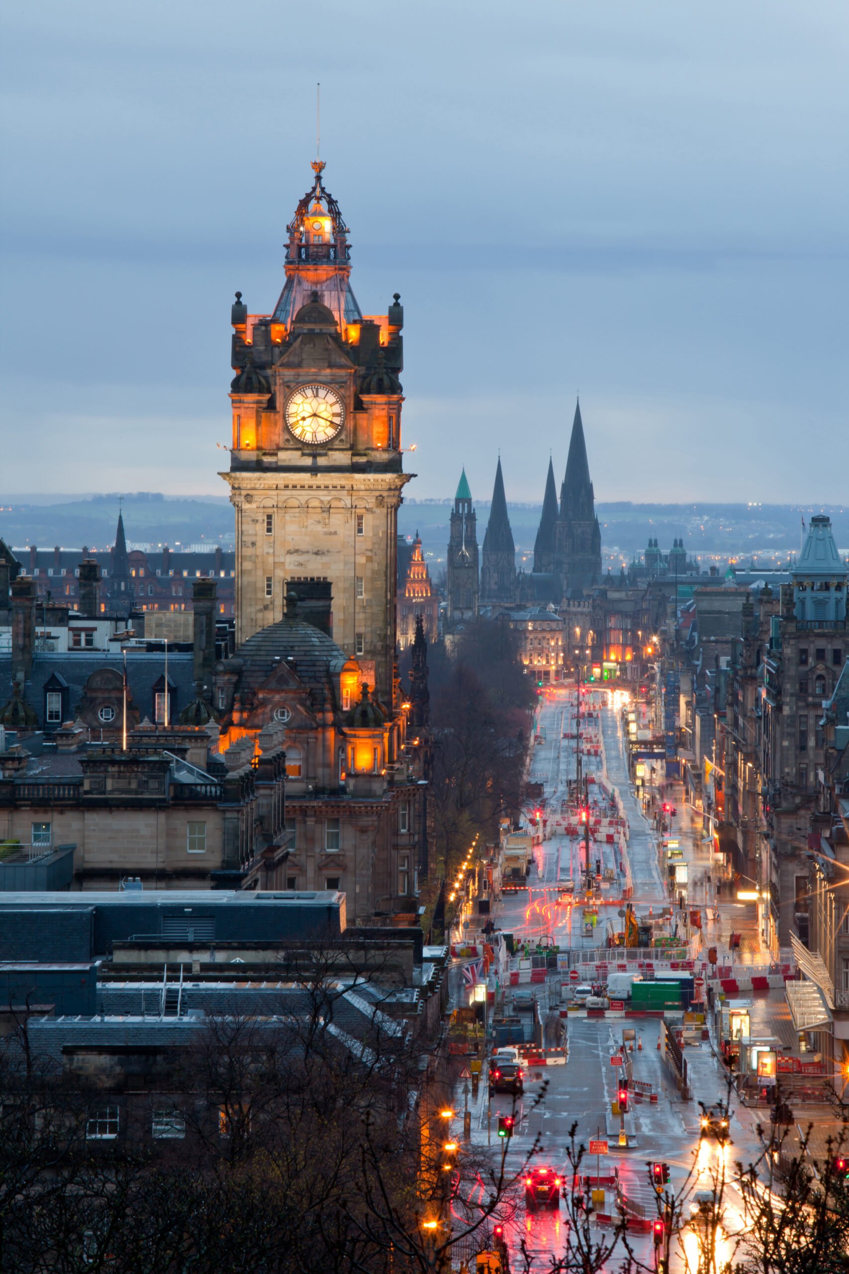 The Best Places To Live in the UK for Expats; Edinburgh with Clock Tower from Calton Hill at dusk Scotland UK