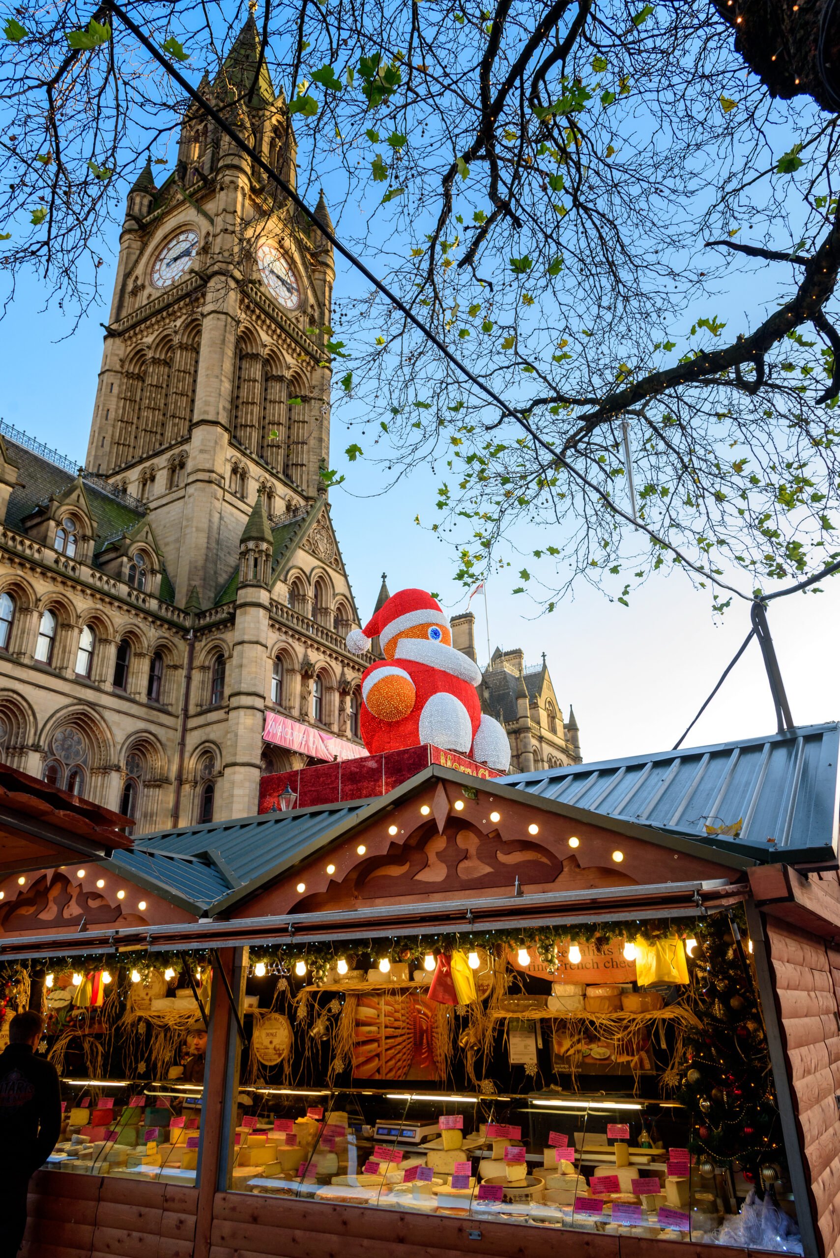 How to Embrace the Festive Cheer; Manchester December Christmas Market  with Santa on town hall, Albert Square, England, UK