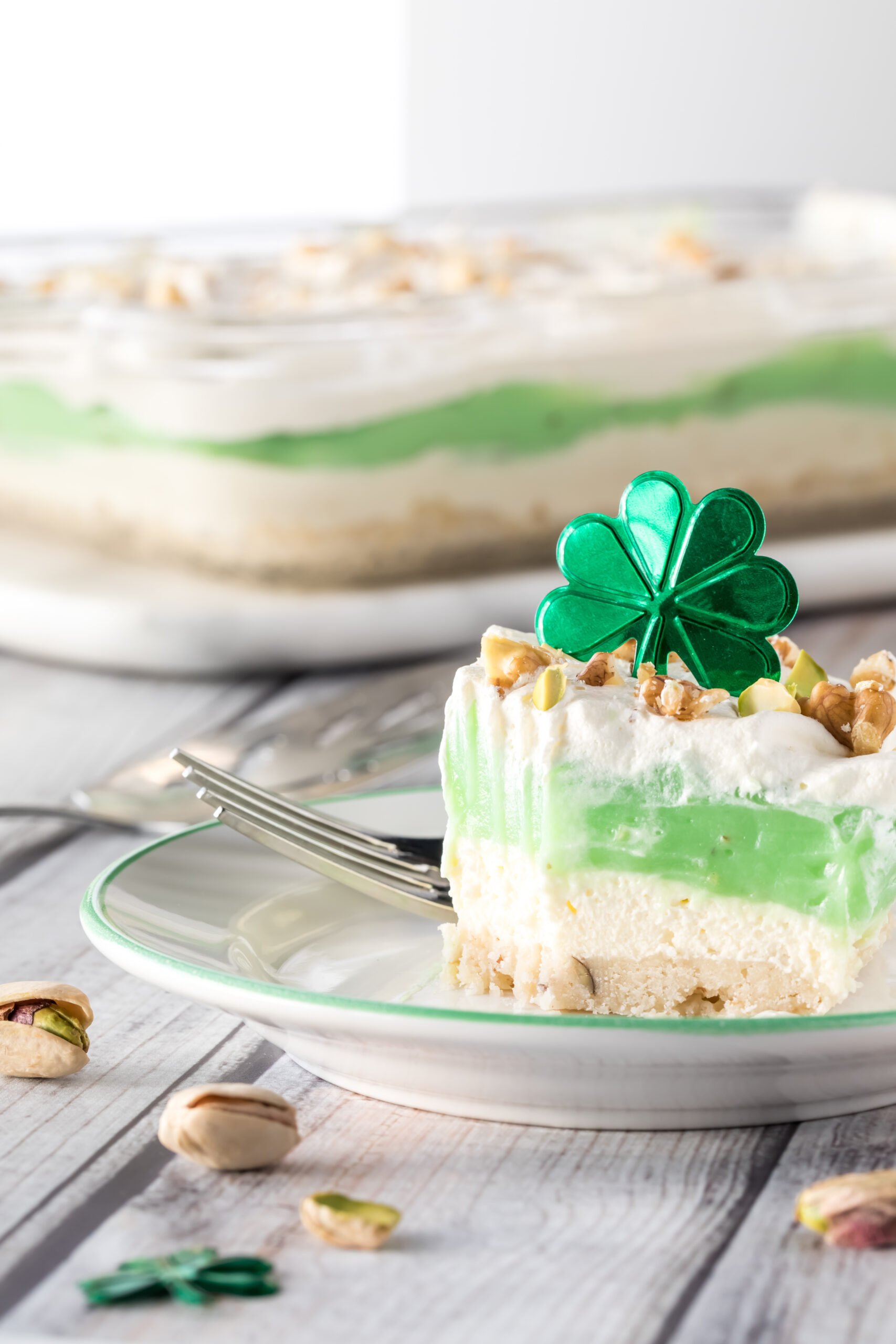 Serving of pistachio pudding and whip cream layered dessert for Saint Patrick's Day, ready for eating. - Top 10 St. Patrick's Day Dessert Recipes; St. Patrick's day recipes for desserts along with other green recipes for this Irish holiday!