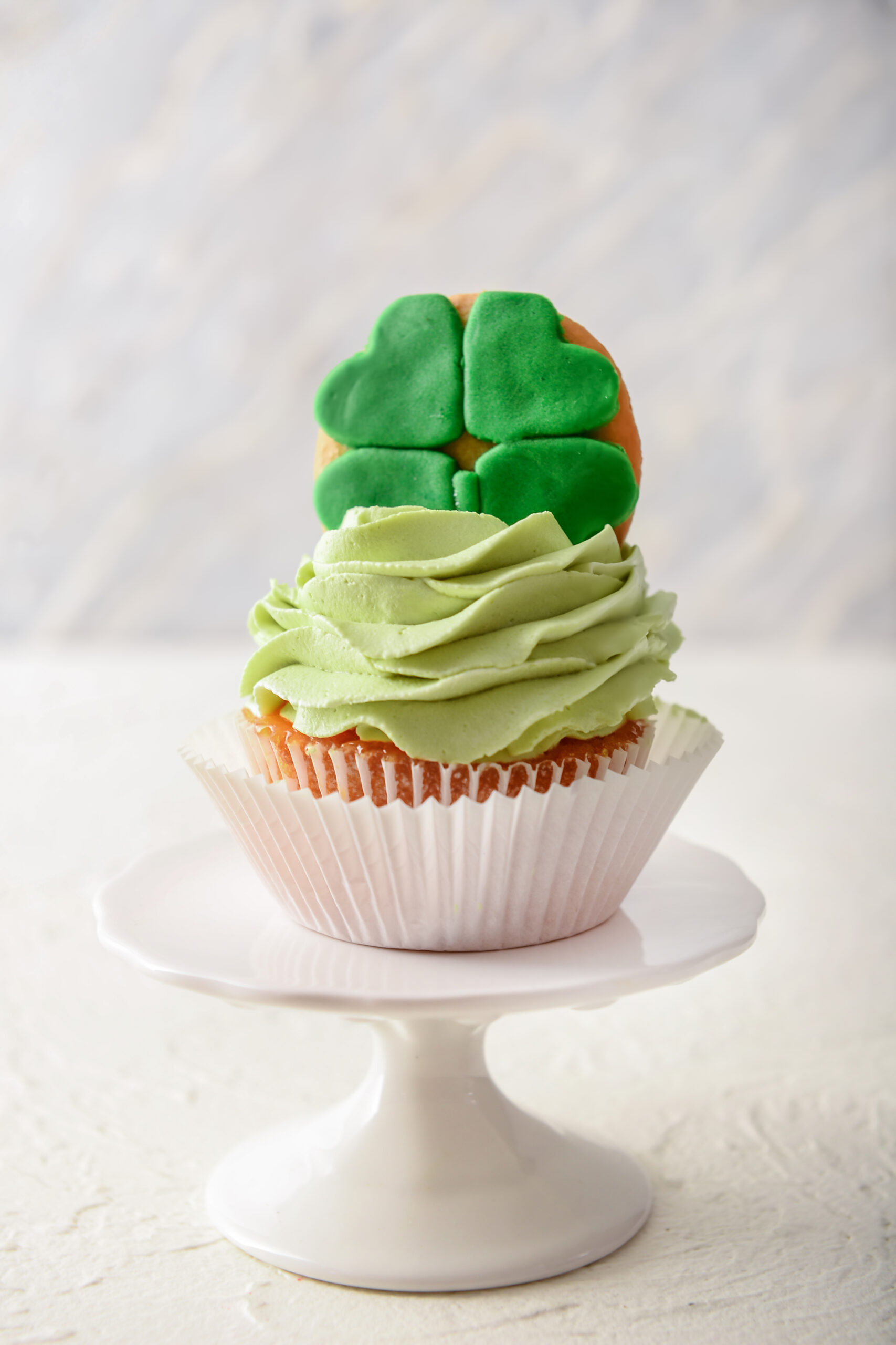 Tasty cupcake for St. Patrick's Day celebration on white table - Top 10 St. Patrick's Day Dessert Recipes; St. Patrick's day recipes for desserts along with other green recipes for this Irish holiday!