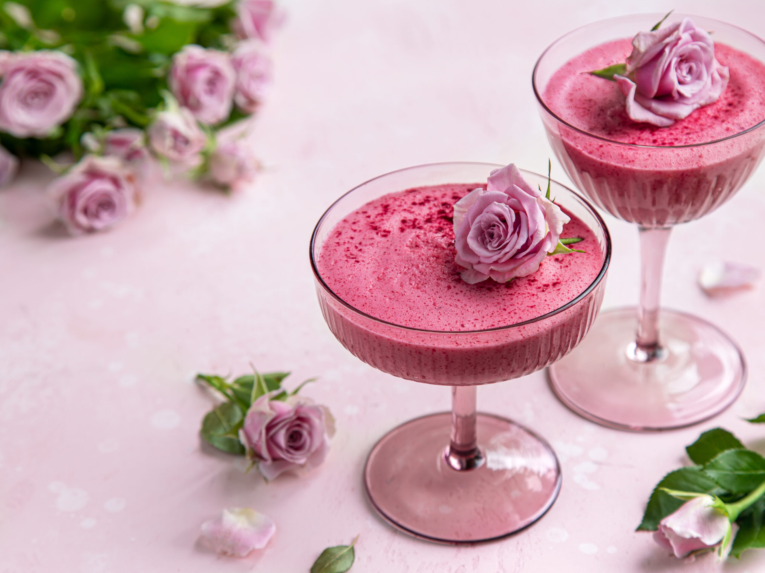 Pink Berry Mousse Recipe; an easy pink dessert recipe that is fluffy and melts in your mouth! Perfect for Valentine's day! {delicious berry mousse in glass, festive dessert for Valentines day, pink background, selective focus}