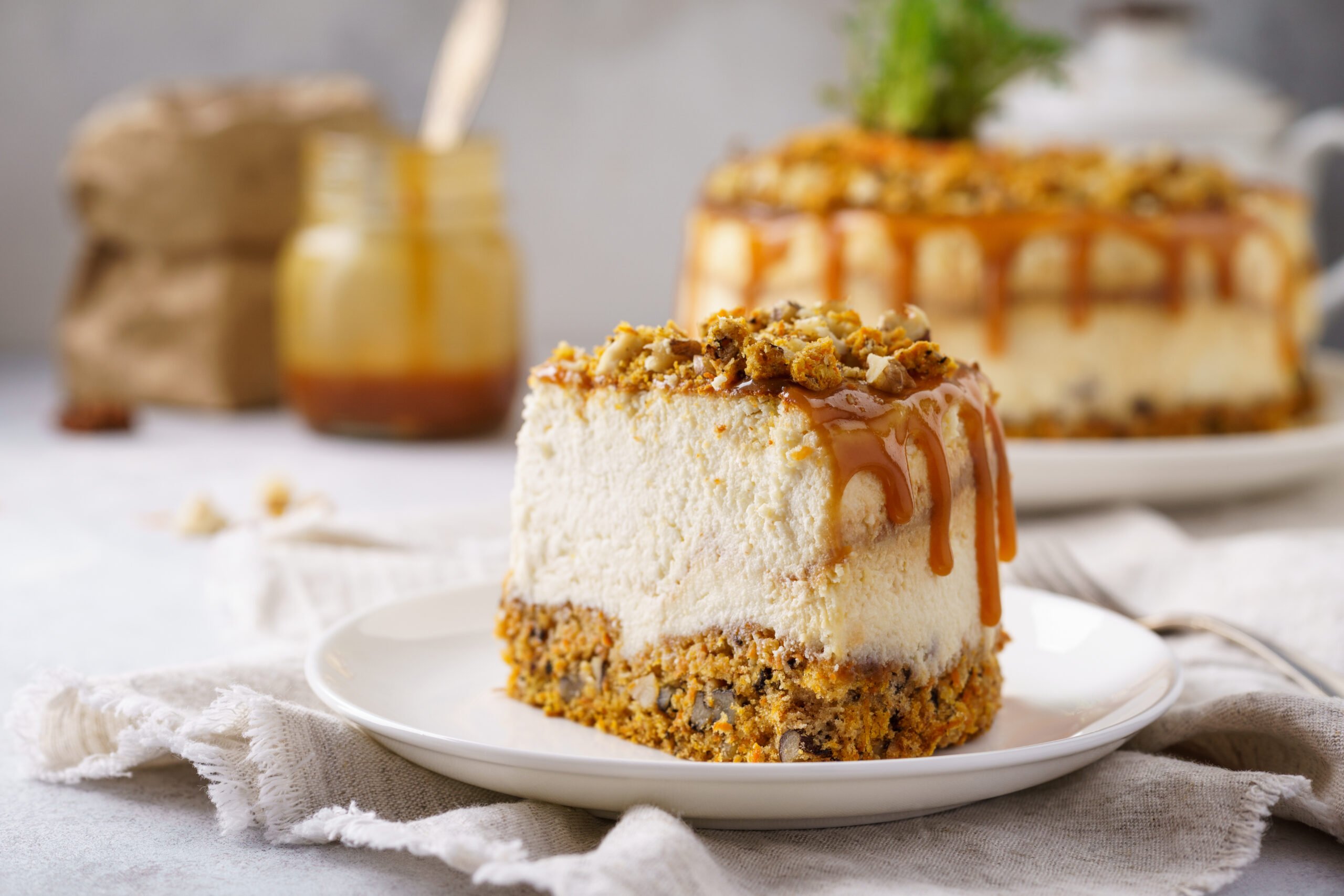 This Caramel Carrot Cheesecake has a carrot cake nutty base with a thick creamy caramel cheesecake topped with salted caramel and nuts.