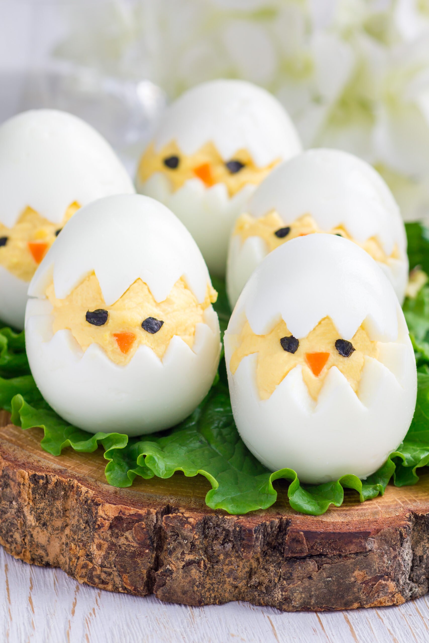 Easy Easter Deviled Eggs Recipe; A dozen eggs with a hard-boiled center and a creamy yellow yolk made to look like chicks for a perfect Easter appetizer.