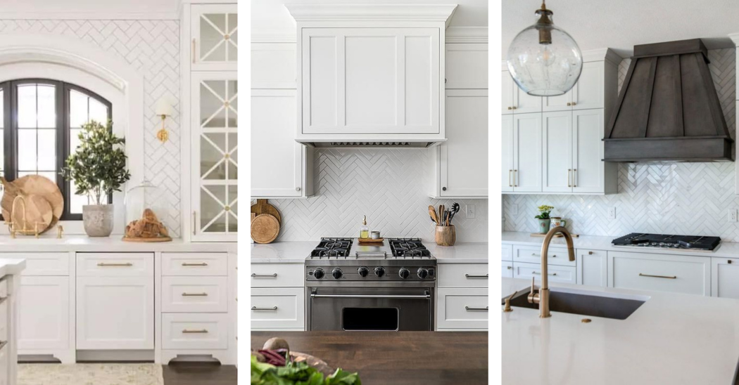 White shaker cabinets, beautiful marble countertop. White wood paneled range hood, white herringbone backsplash tiles above a stainless steel oven range.