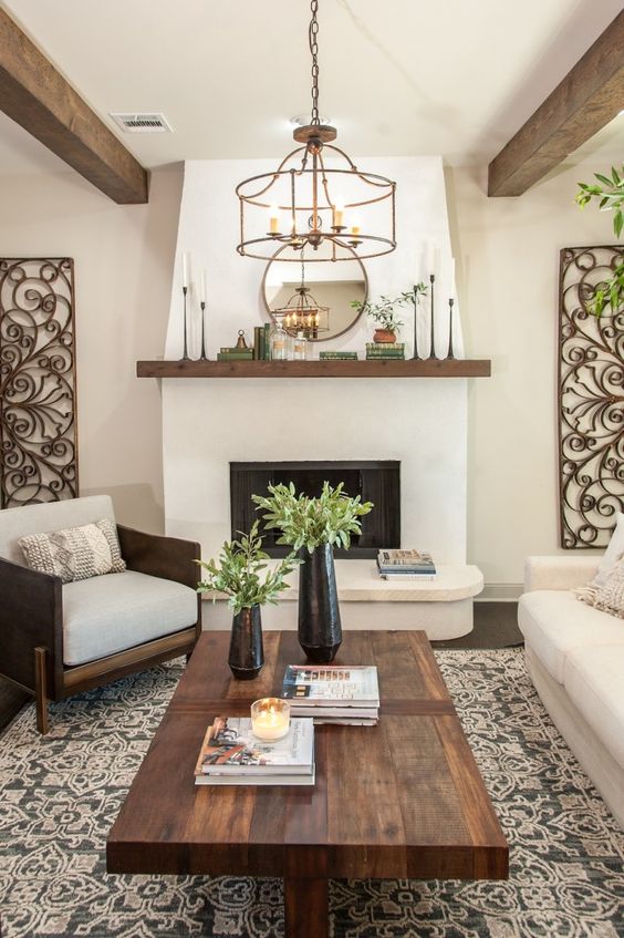 Living room by Joanna Gaines with double-sided fireplace and rustic exposed brick in this Jackson home