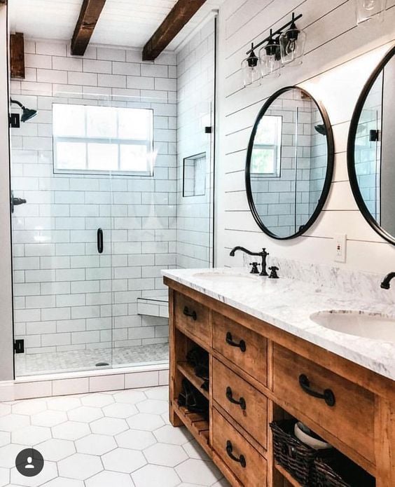 How to Create A Perfect Farmhouse Bathroom; wood vanity, black metal mirror, glass shower, white shiplap walls